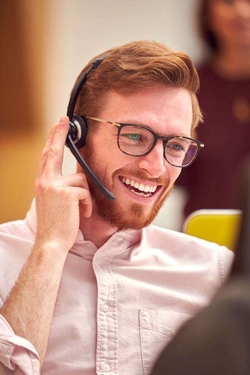Sales rep wearing headset talking in an engaging conversation