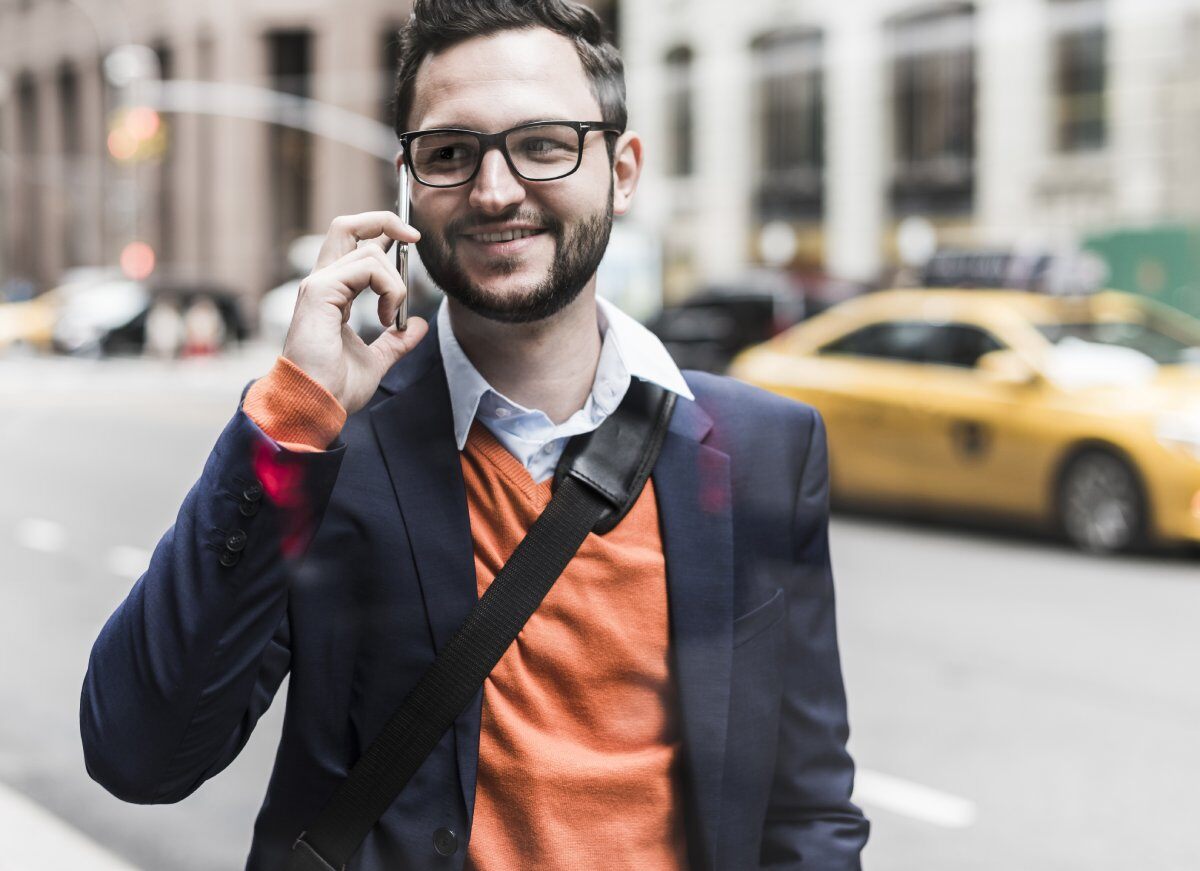 US New York City businessman answering smartphone