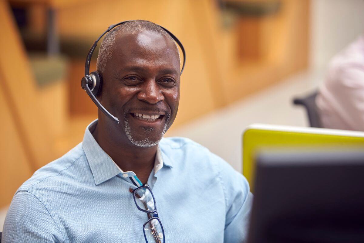 Portrait of a mature sales rep wearing phone heads in a successful conversation