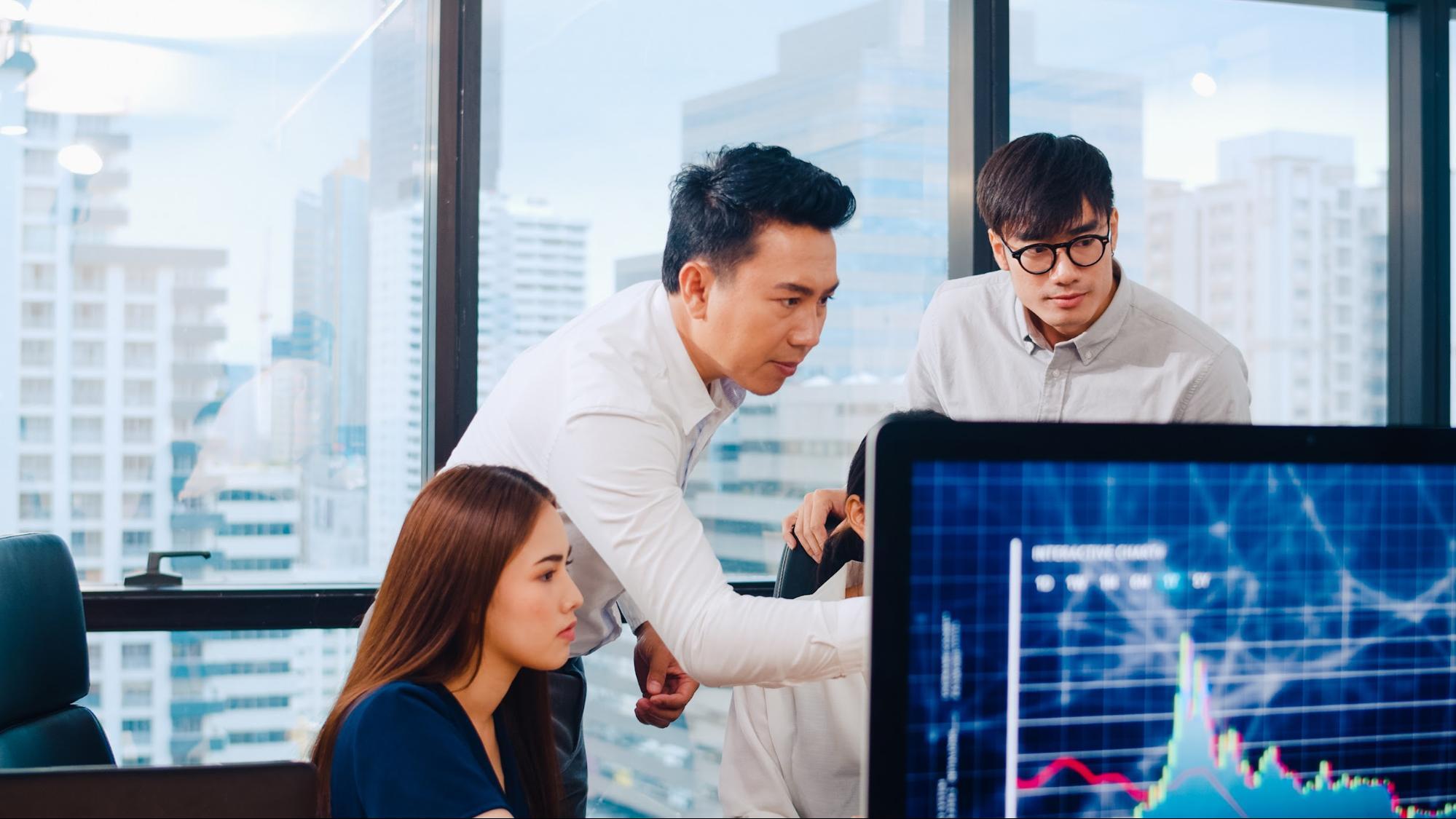 Business team analyzing customer engagement strategies on data dashboard in modern office.